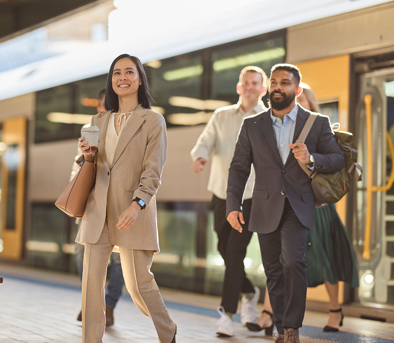 Commuters from diverse backgrounds exiting a train on their way to work