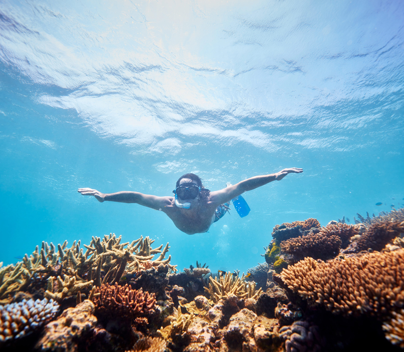 Hiker walking on sandy beach at Maria Island, East Coast Tasmania
