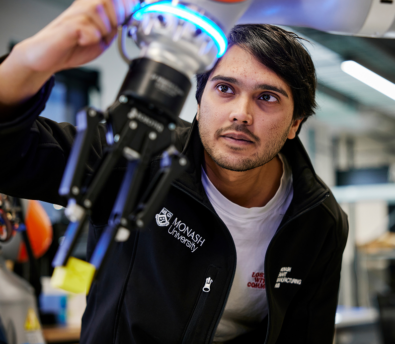 Robot engineering student fine-tuning a robot