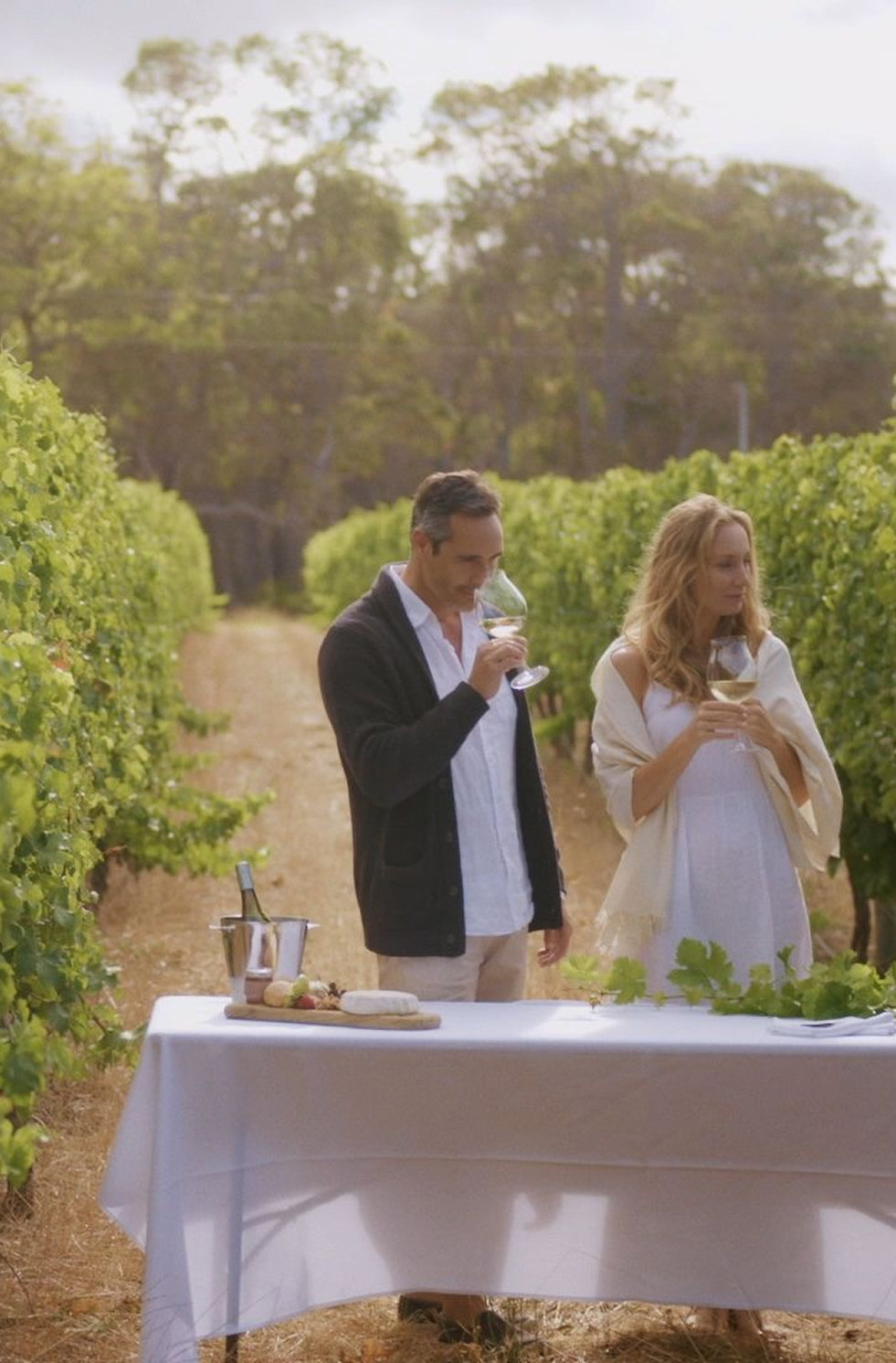 Guests sampling wine among vines in Margaret River, Western Australia