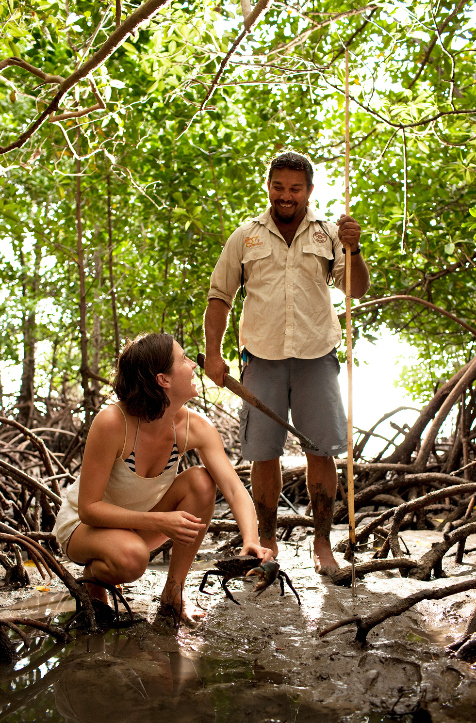 Kuku Yalanji man with spear catching mud crab in the Daintree, Tropical North Queensland