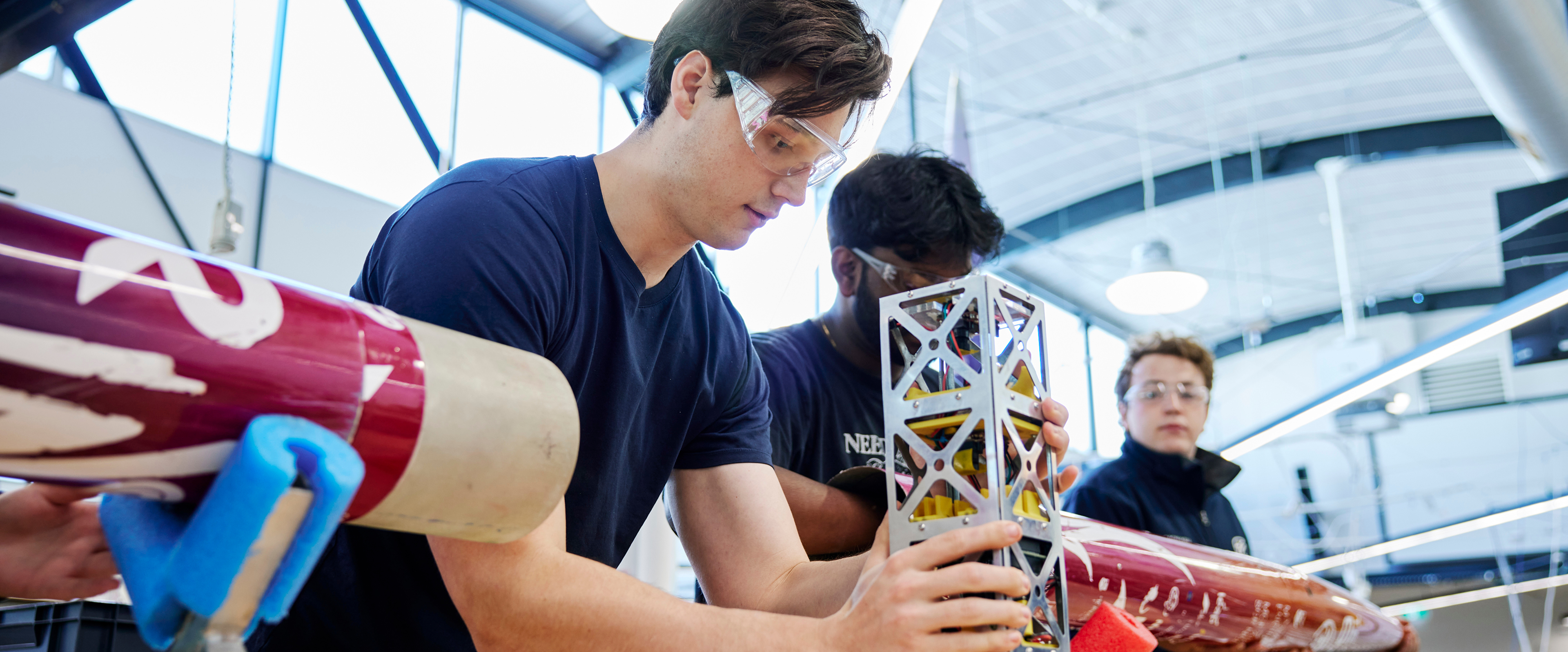 Group of three students conducting a propulsion experiment