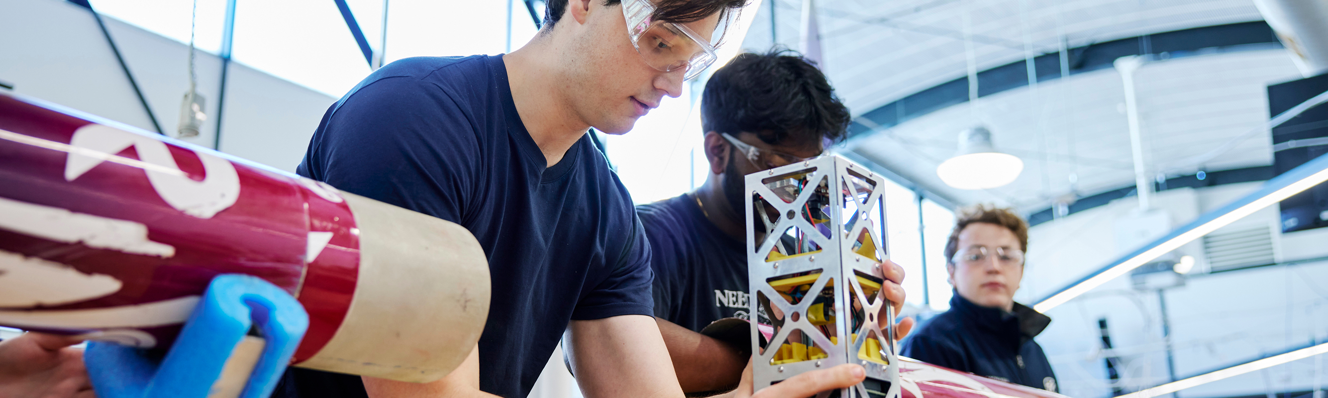 Group of three students conducting a propulsion experiment