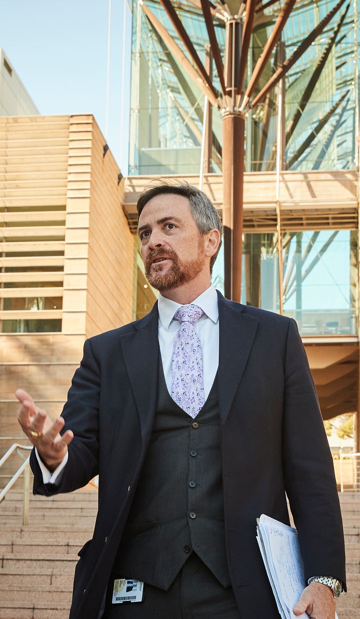 Education Minister Jason Clare and Professor Attila Brungs, Vice-Chancellor & President, holding papers in front of the UNSW building