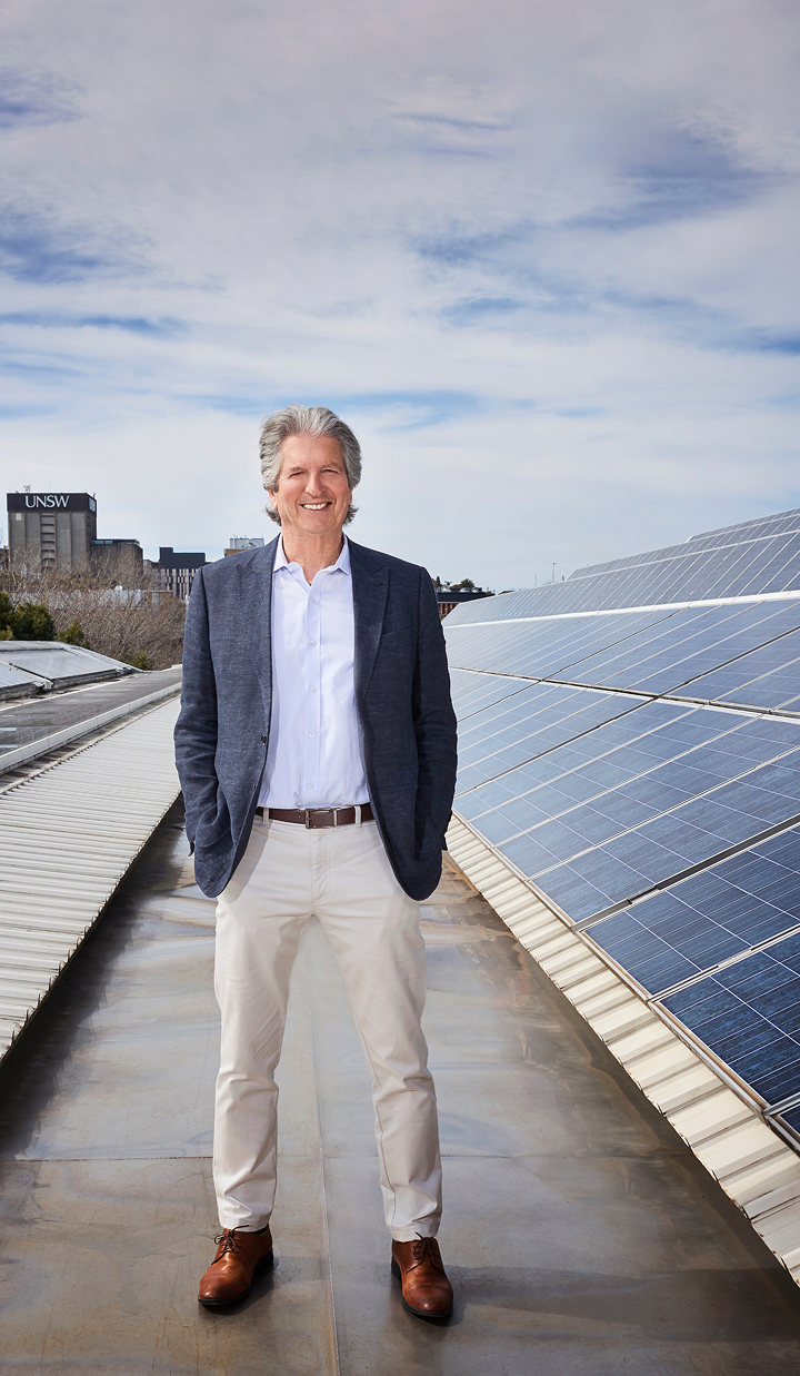 Professor Martin Green standing on a rooftop with solar panels