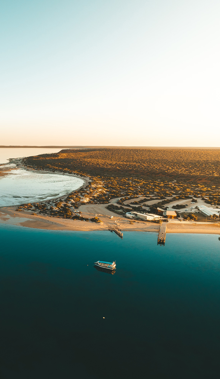 Aerial view of a coastal resort and lagoon at sunset