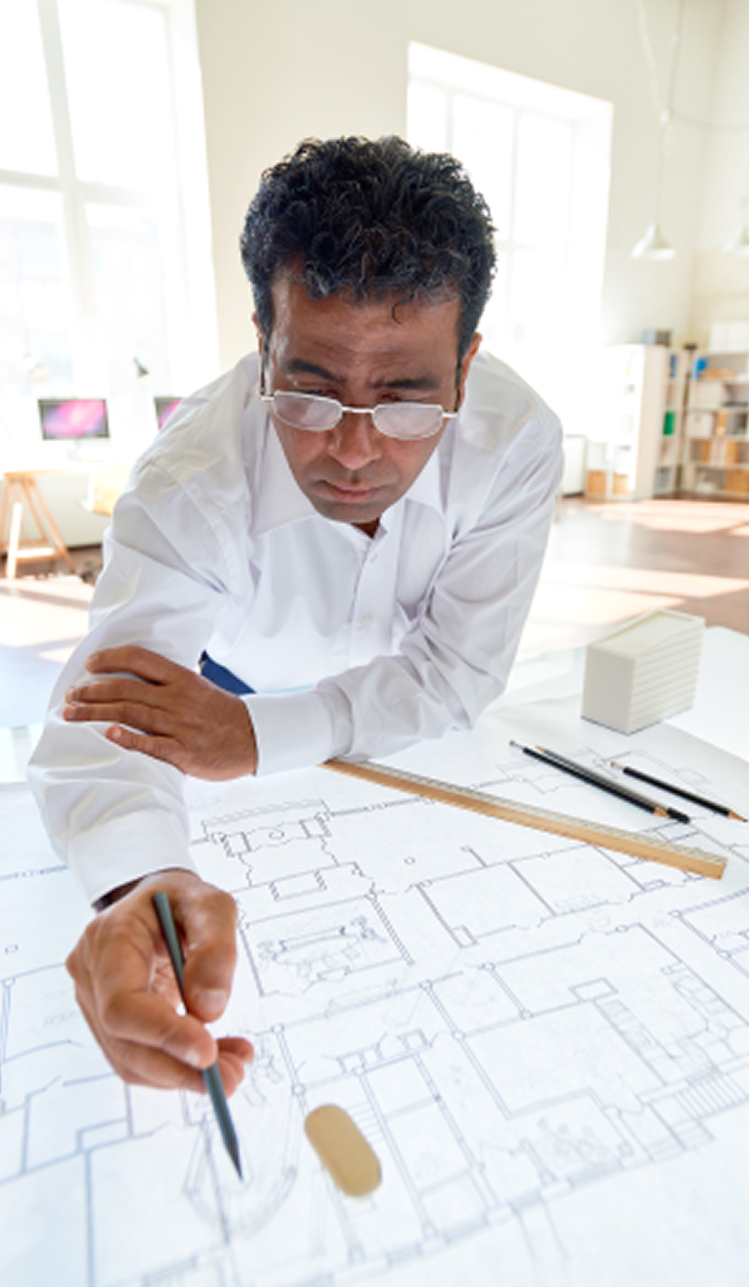 Architect reviewing blueprints