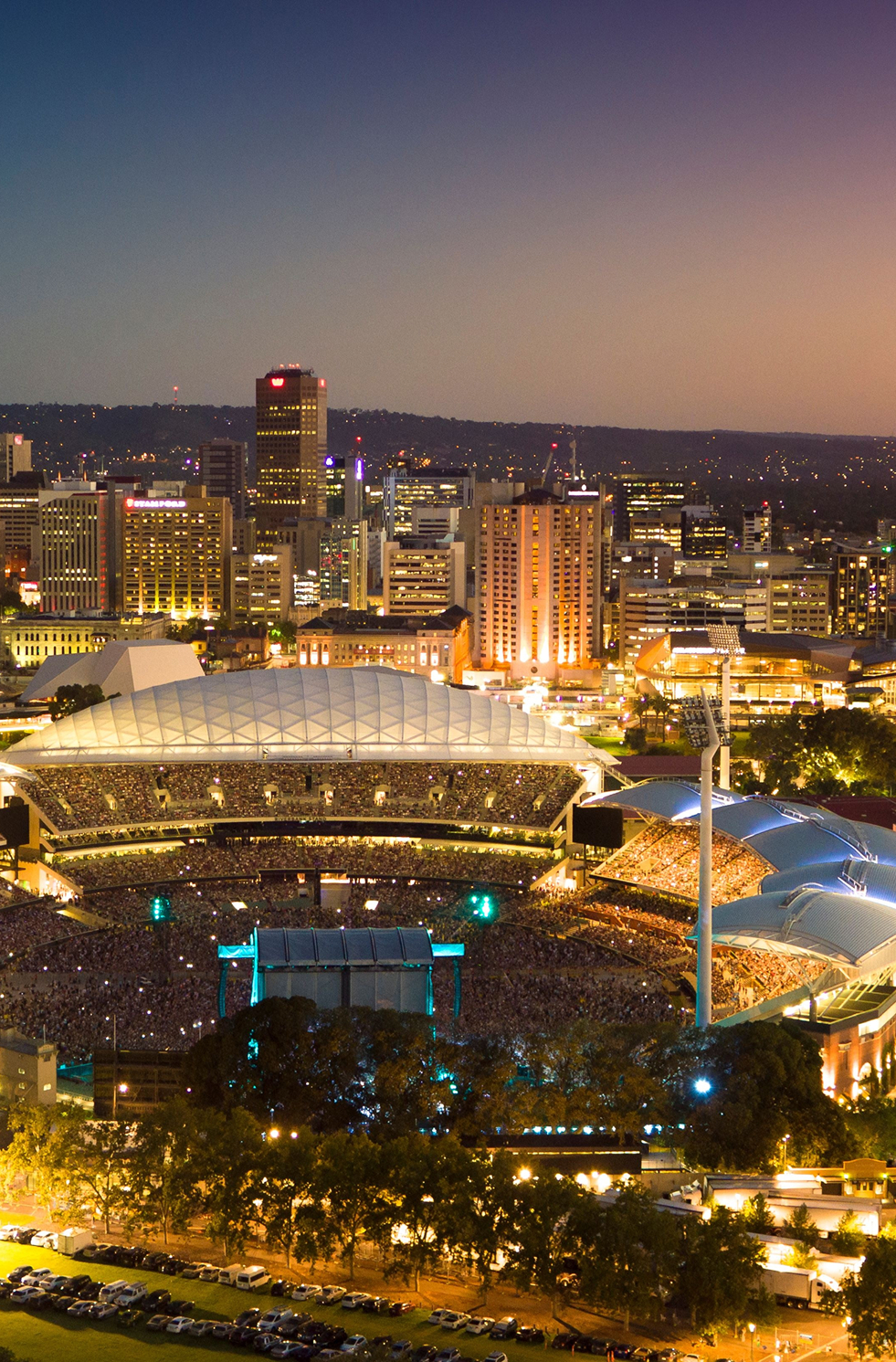 Adelaide Oval aerial at sunset, iconic stadium surrounded by city and parklands, Adelaide, SA.