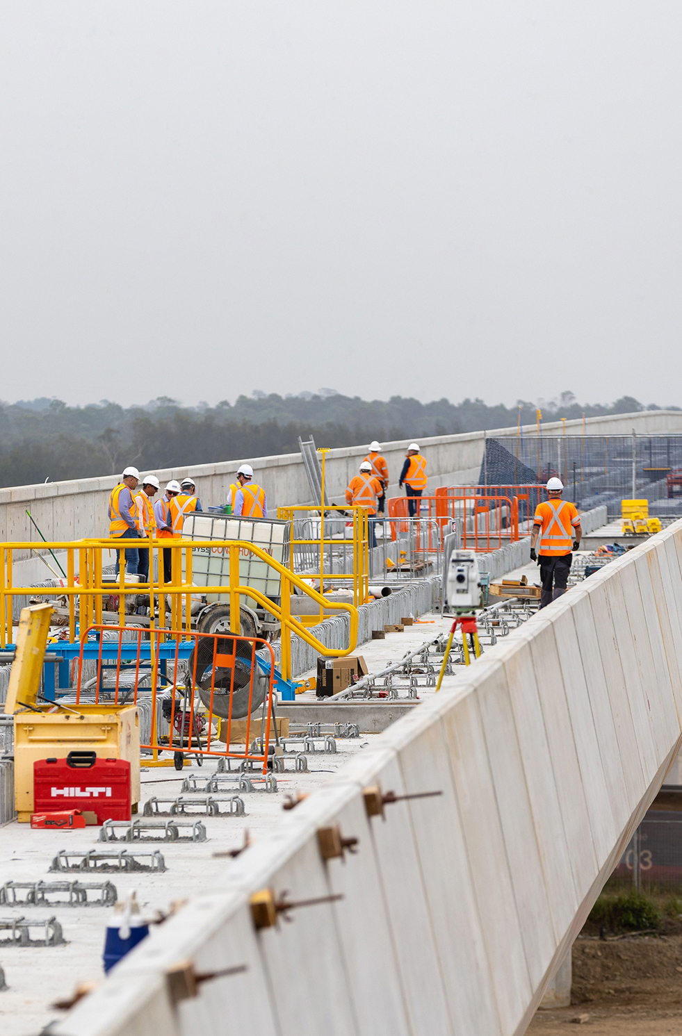 Construction workers building new road infrastructure together.