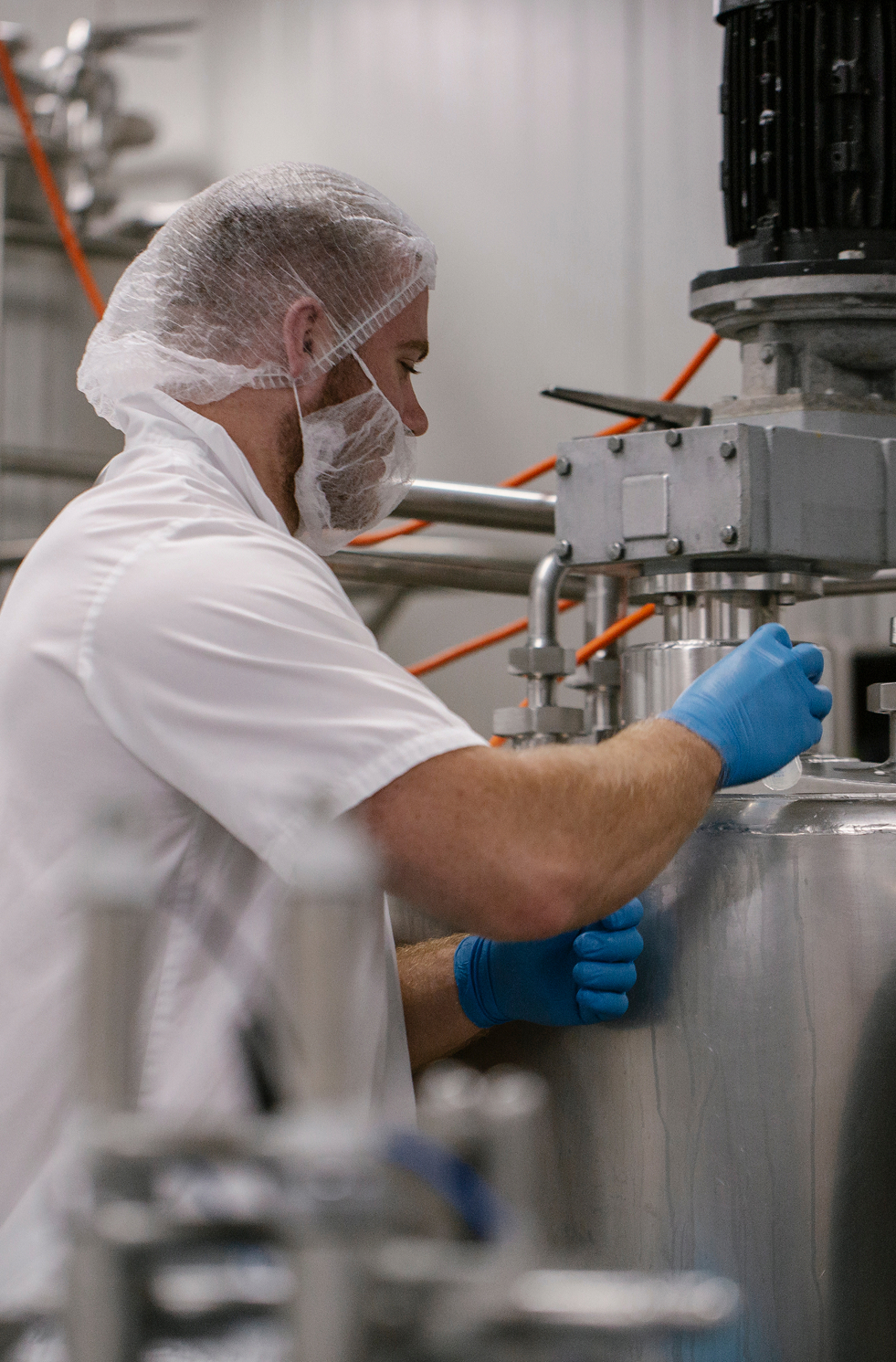 Factory worker wearing PPE at Westhaven Dairy food manufacturing facility.