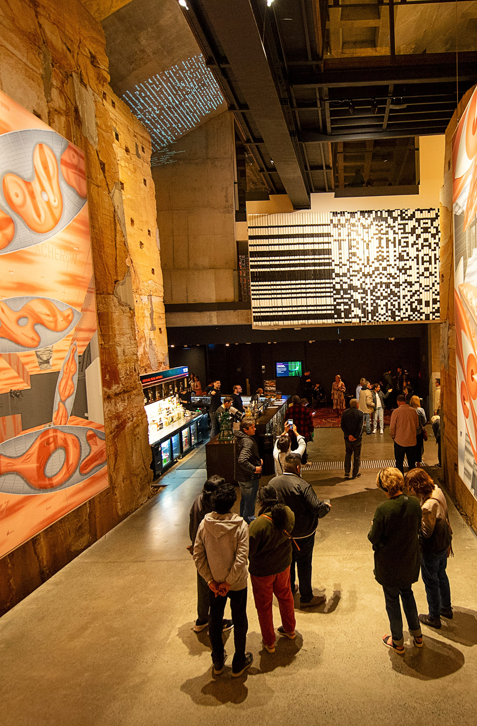 Guests walking through an exhibition hall at MONA.