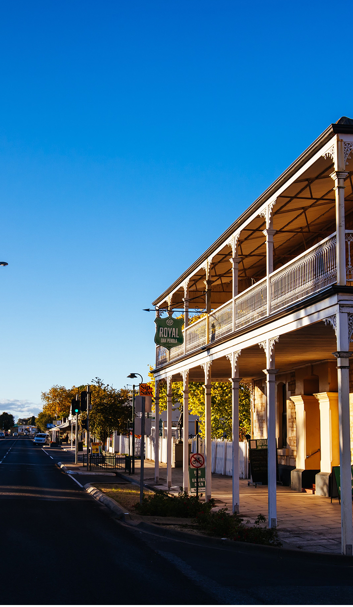 Historic Australian pub with a balcony at sunset