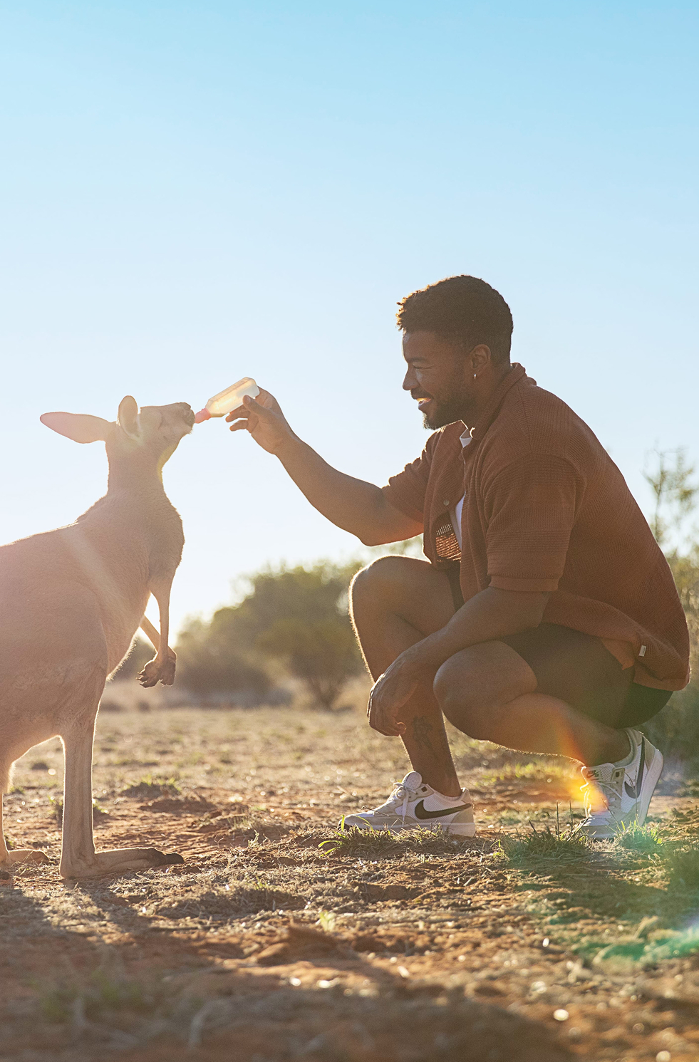Man feeding kangaroo, Alice Springs, Central Australia
