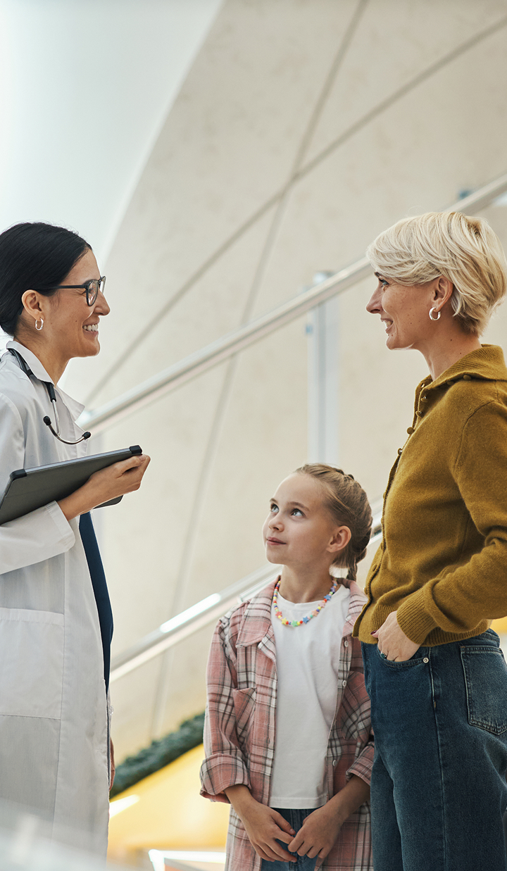 middle-aged-woman-and-child-talking-with-female-doctor