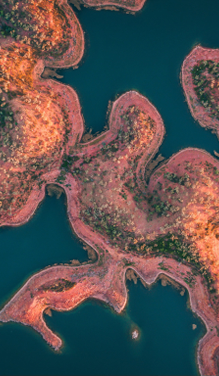 aerial-view-of-red-earth-coastline-with-blue-water