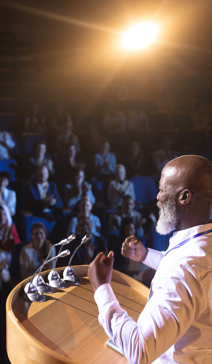 businessman-standing-near-podium-and-giving-speech