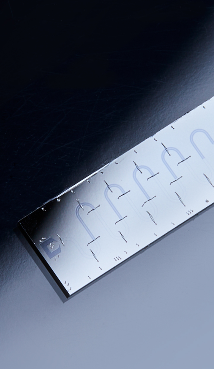 A dark matter chip resting on a surface, illuminated by a spotlight, with a high-tech and polished appearance.