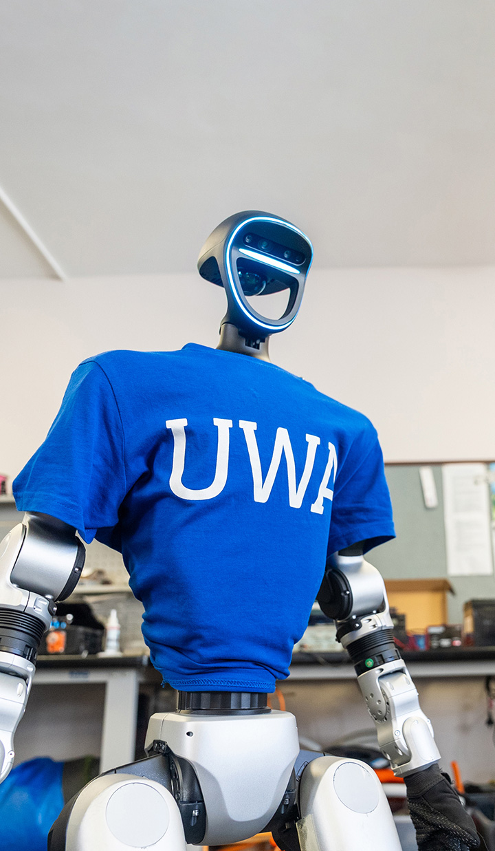 A robot wearing a University of Western Australia shirt