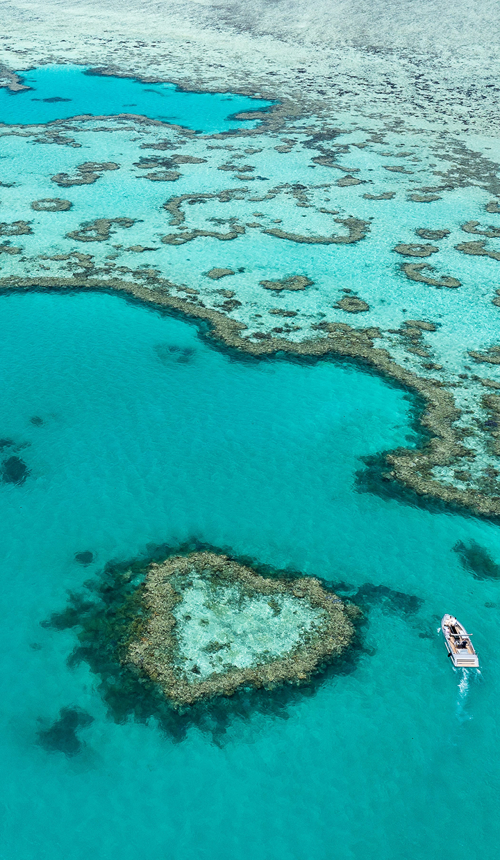 Aerial view of the heart-shaped coral formation in the Great Barrier Reef.