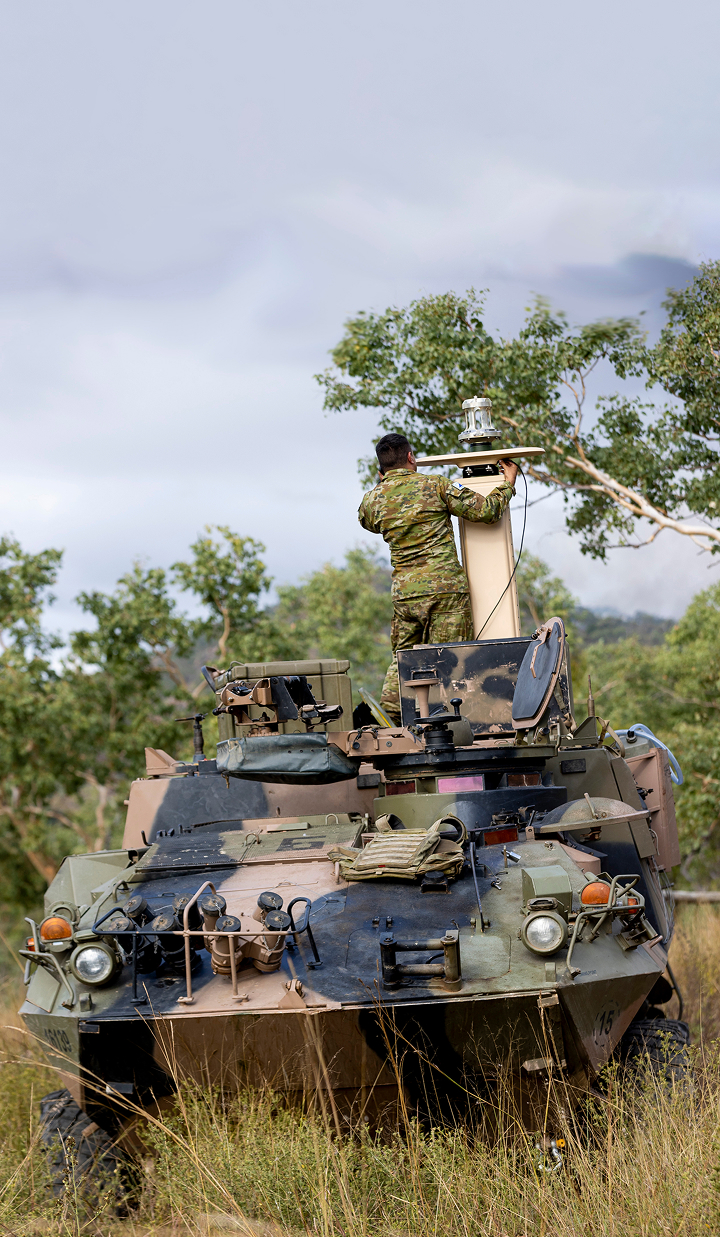 Australian Army soldier sets up a long-range RF sensor on an armoured vehicle at Lavarack Barracks, Queensland.