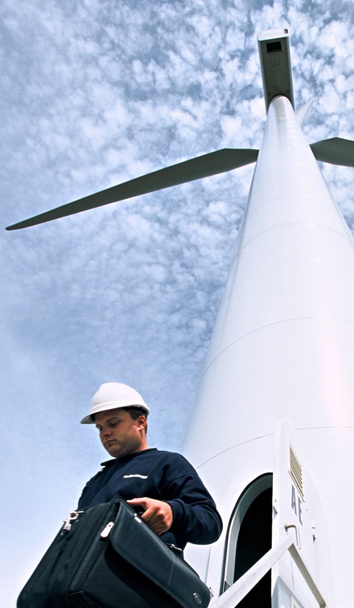 Engineer exiting the base of a wind turbine.