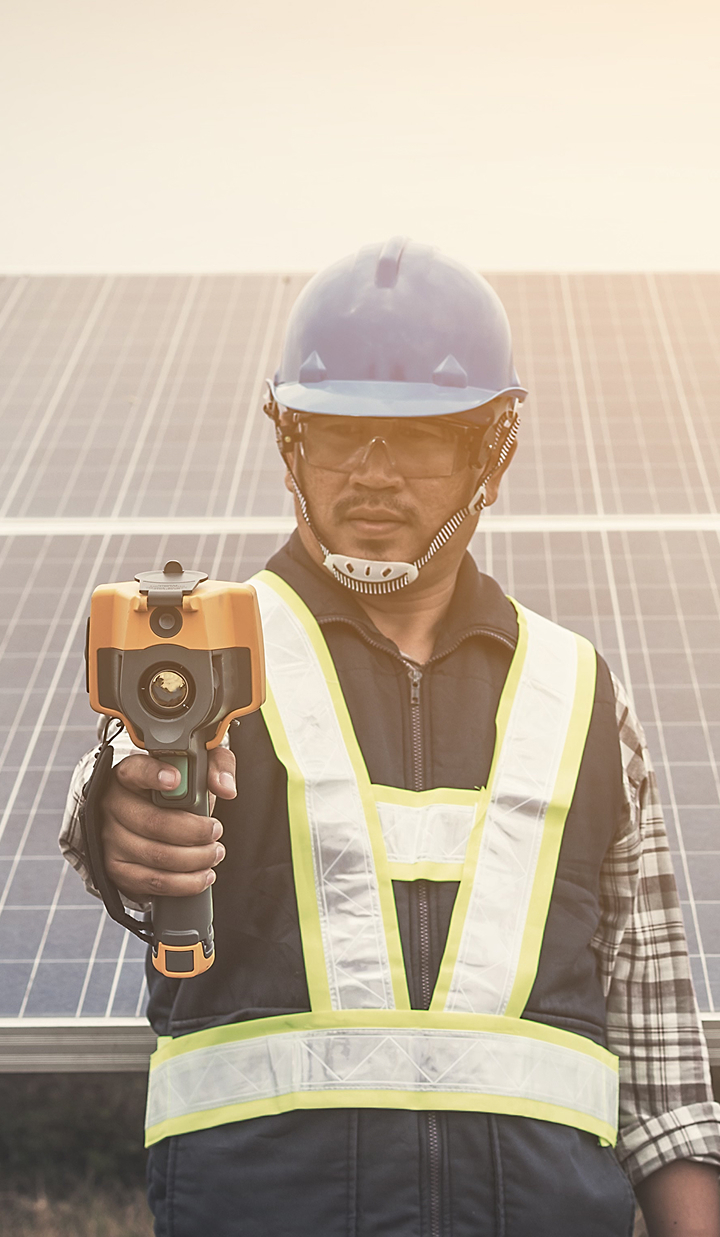 Engineer working in front of solar panels