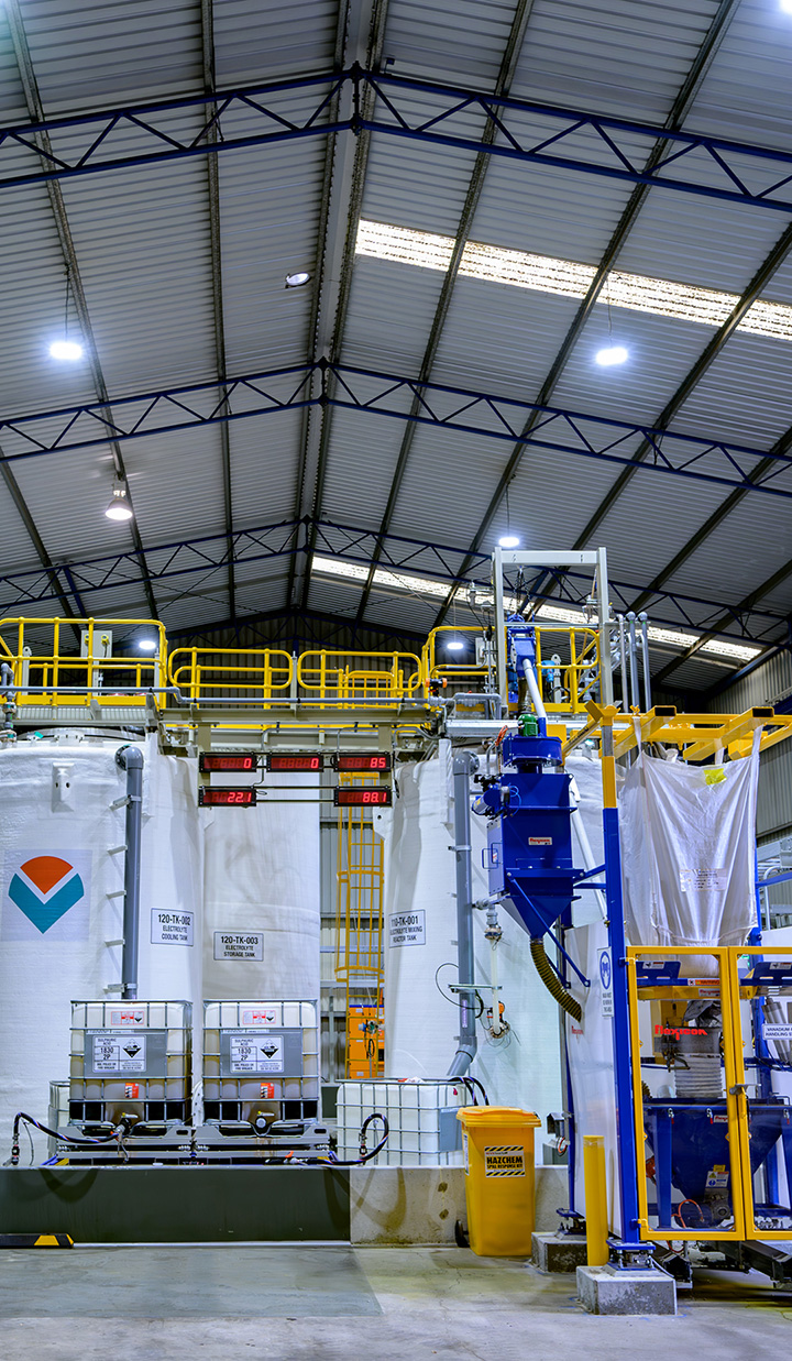 Warehouse with large tanks and pipes.