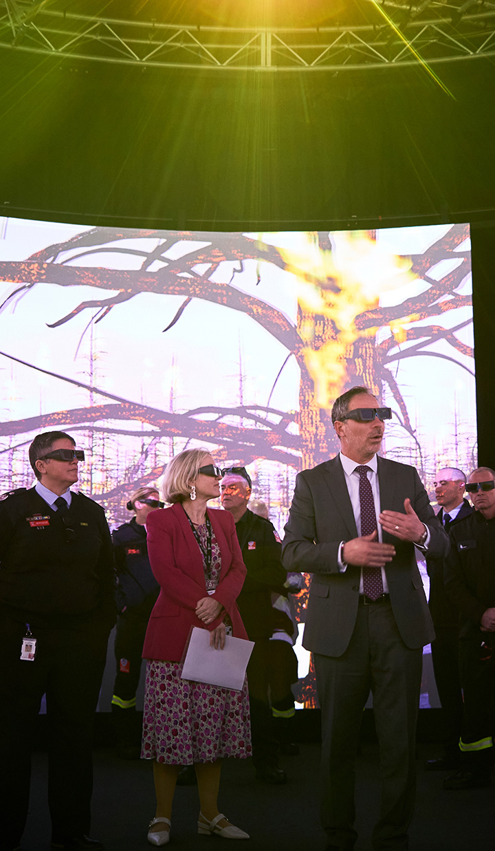 Group in front of burning tree display wearing glasses.
