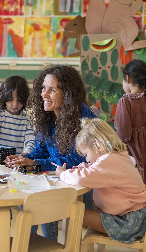 Happy encouraging teacher speaking to her class