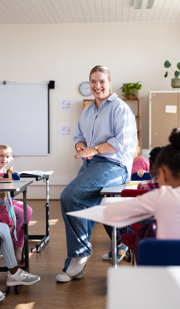 School-female-teacher-smiling-and-engaging-with-students