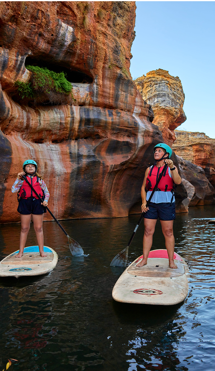mother-and-daughter-paddle-boarding-through-red-rock-gorge