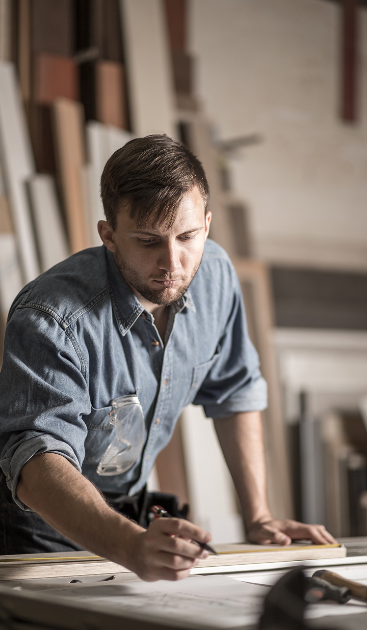 young-busy-hardworking-carpenter-at-work-in-work