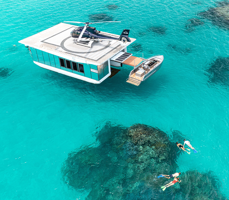 Floating helipad platform anchored at a reef for marine research operations