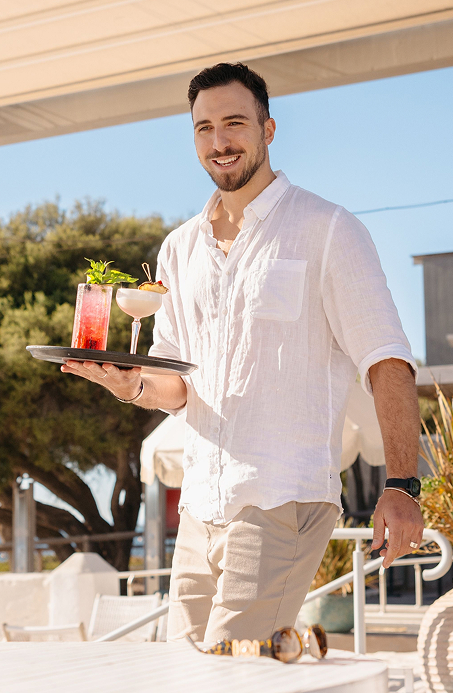 Hospitality service featuring vibrant cocktails with stunning panoramic beach and ocean views
