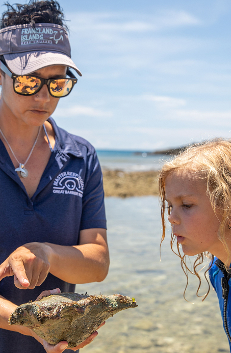 Marine biologist guides a group on an island walk and nature tour