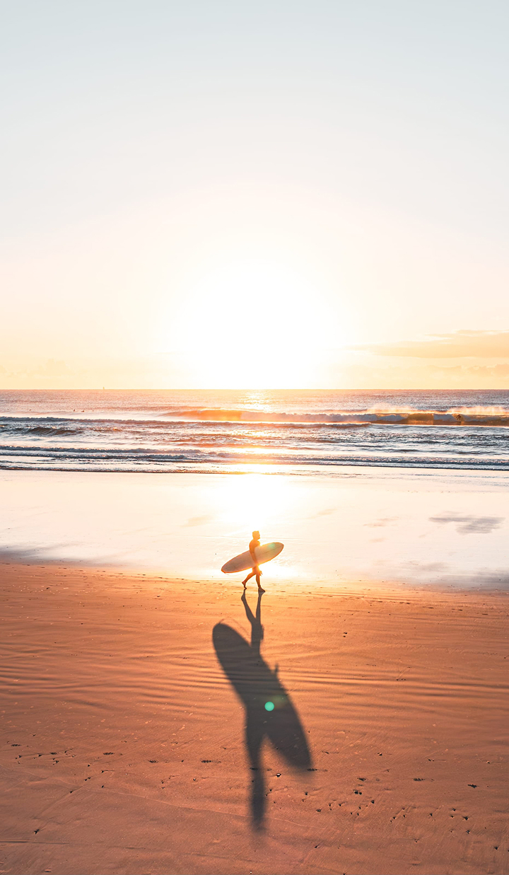 Lone surfer on beach