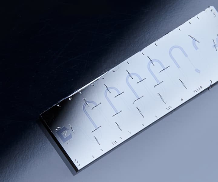 A dark matter chip resting on a surface, illuminated by a spotlight, with a high-tech and polished appearance