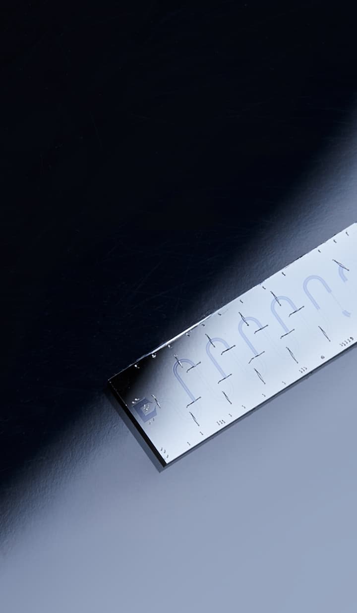 A dark matter chip resting on a surface, illuminated by a spotlight, with a high-tech and polished appearance