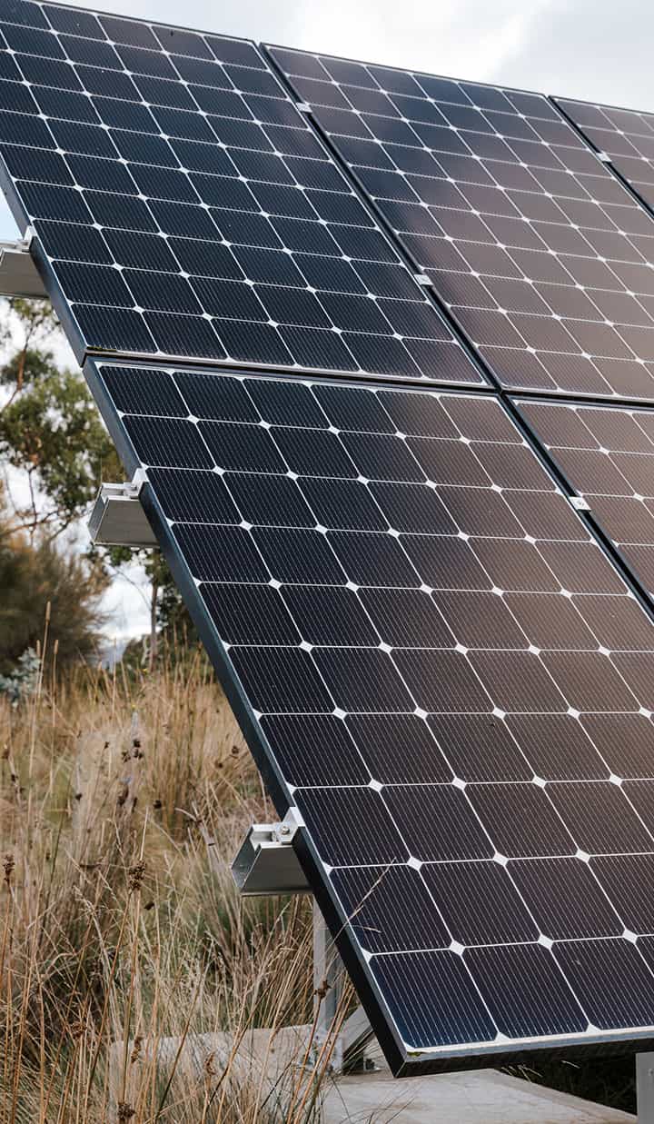 Close-up of solar panels in a grassy outdoor area.