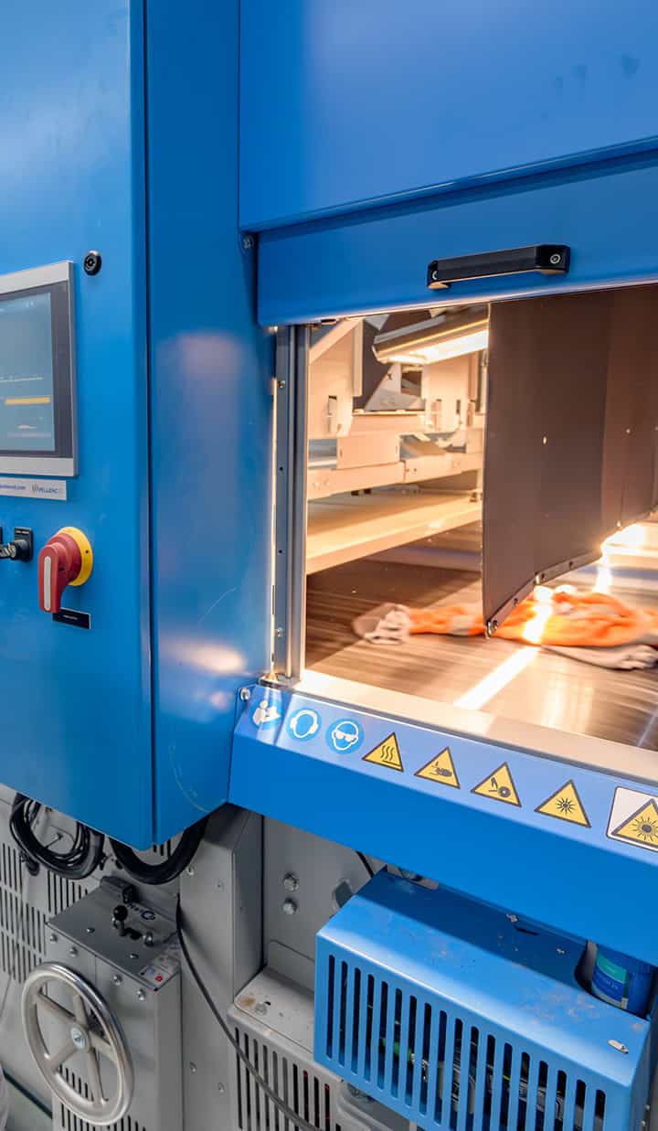 Medicine or material being processed inside a brightly lit industrial machine.