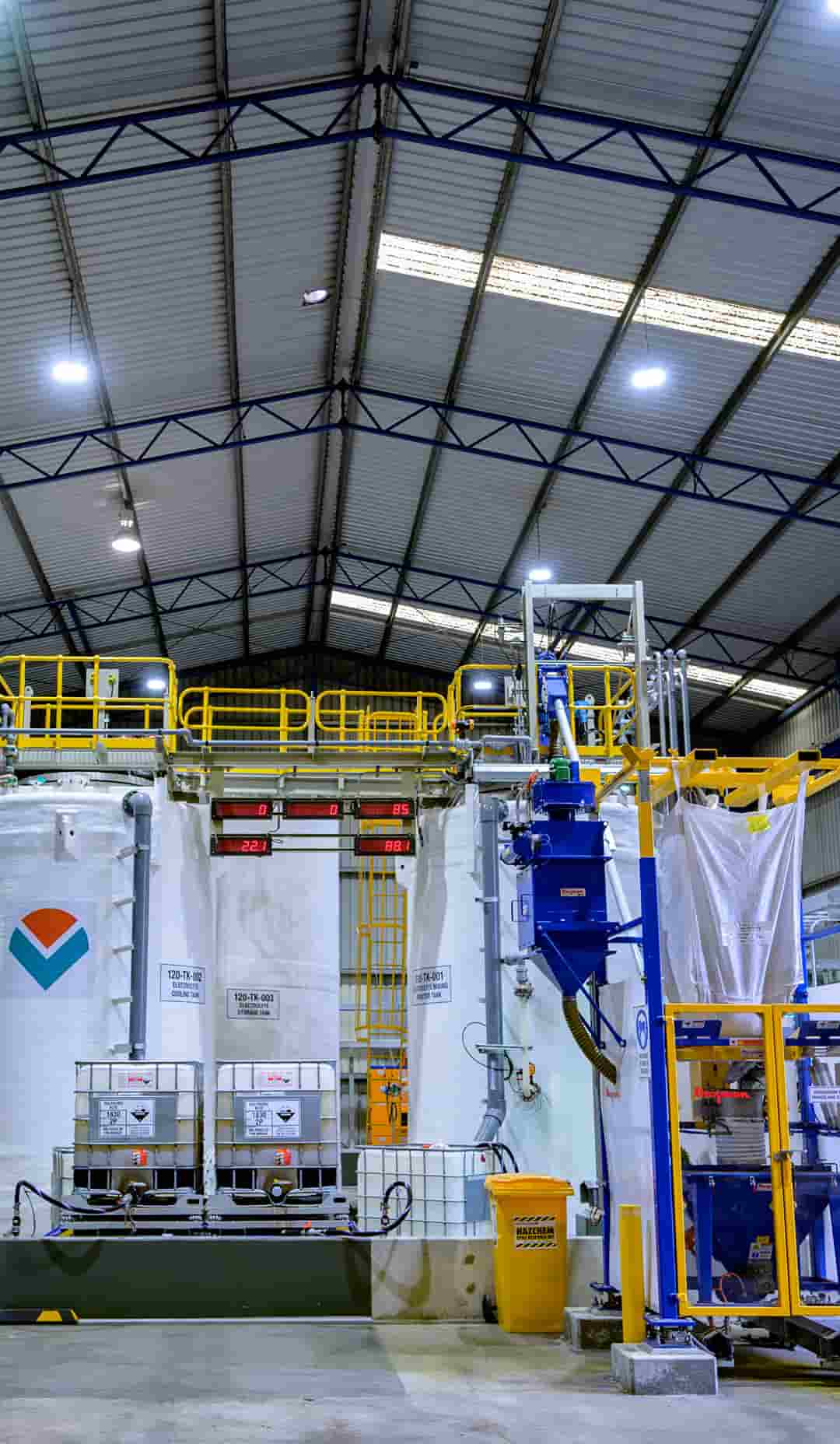Warehouse with large tanks and pipes.