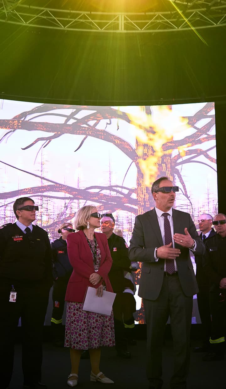 Group in front of burning tree display wearing glasses.