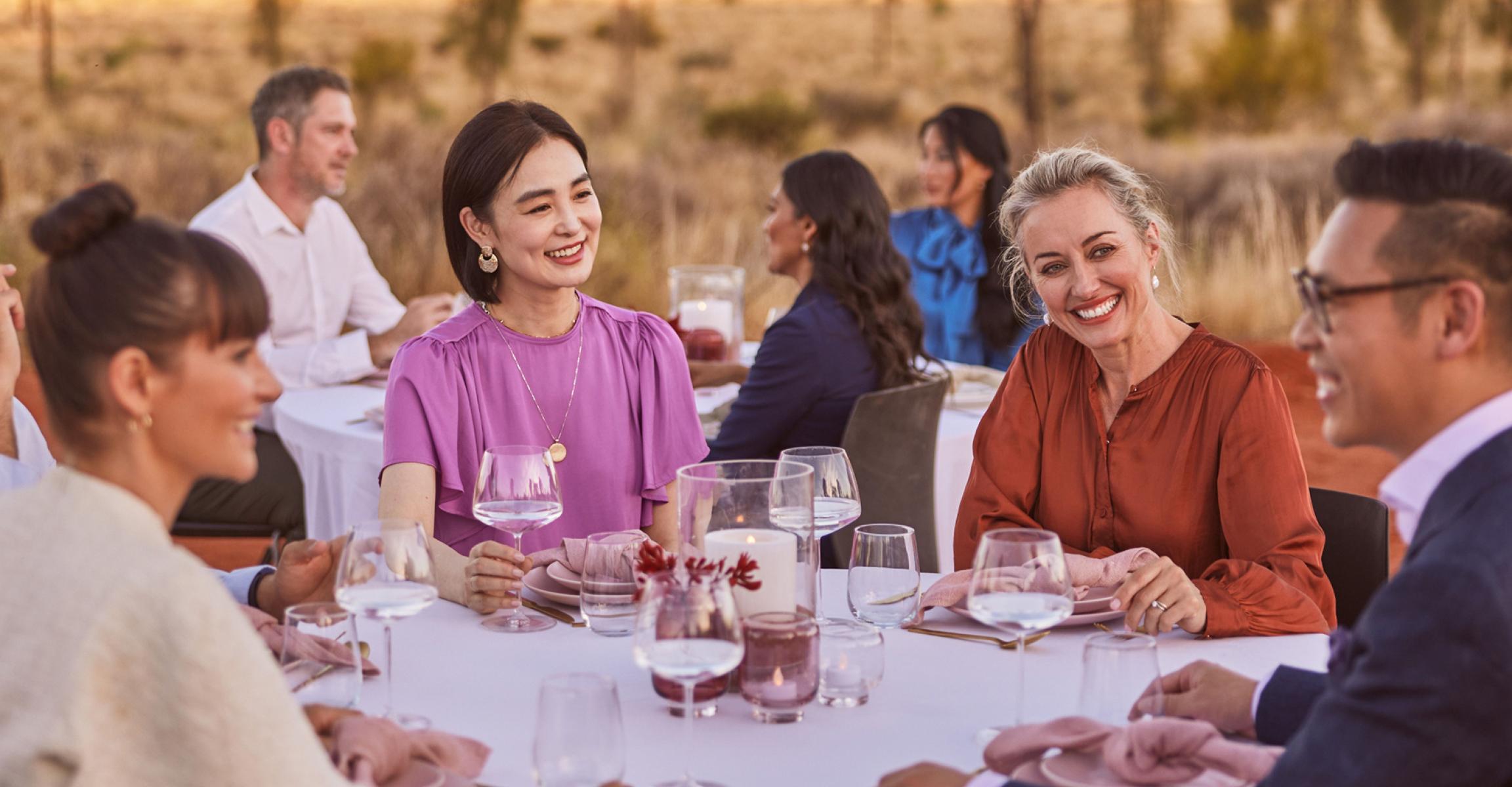 Diverse group of people dining outdoors together