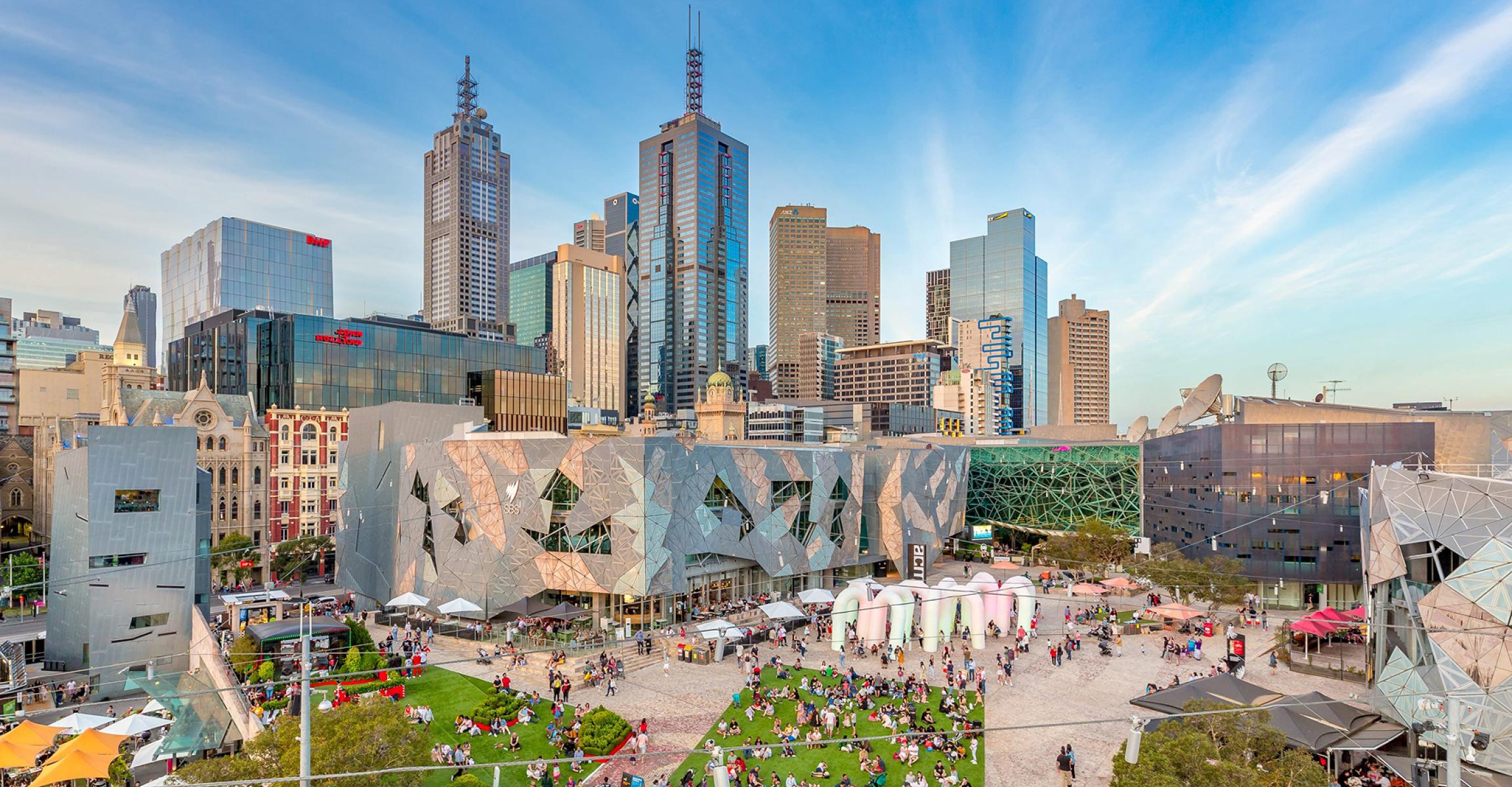 Elevated view of a bustling Federation Square in Melbourne CBD with crowds enjoying a sunny event