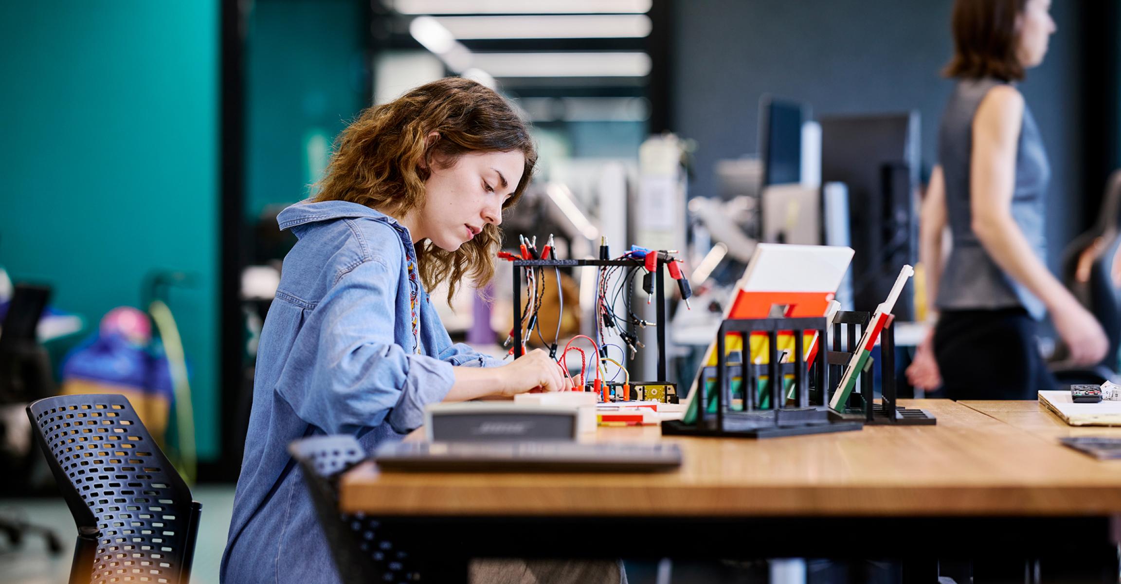 Student assembling a circuit board at university