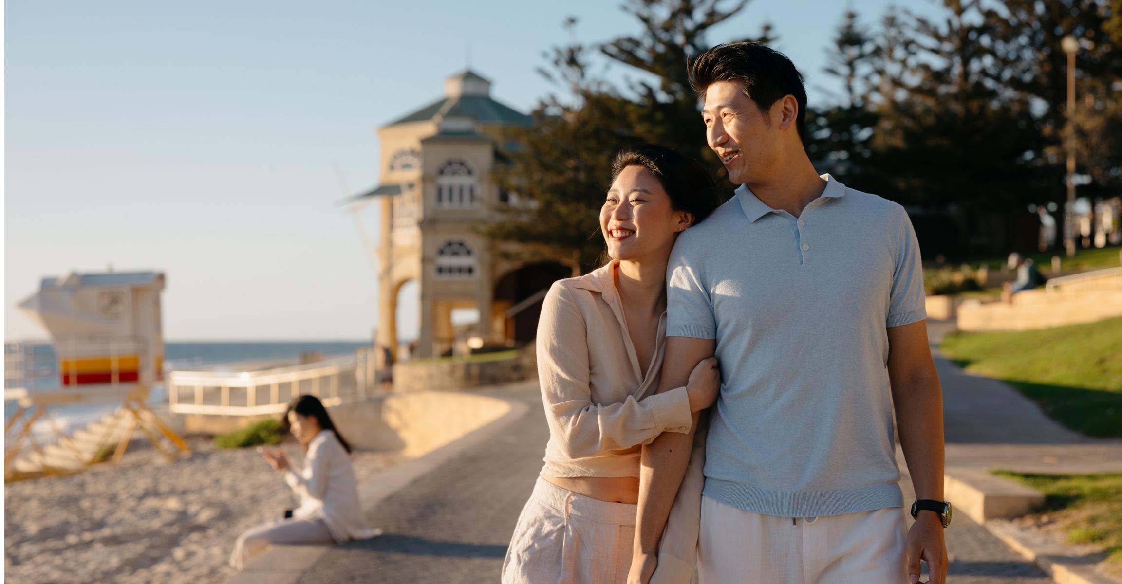 Couple walking together along the beach, enjoying the seaside