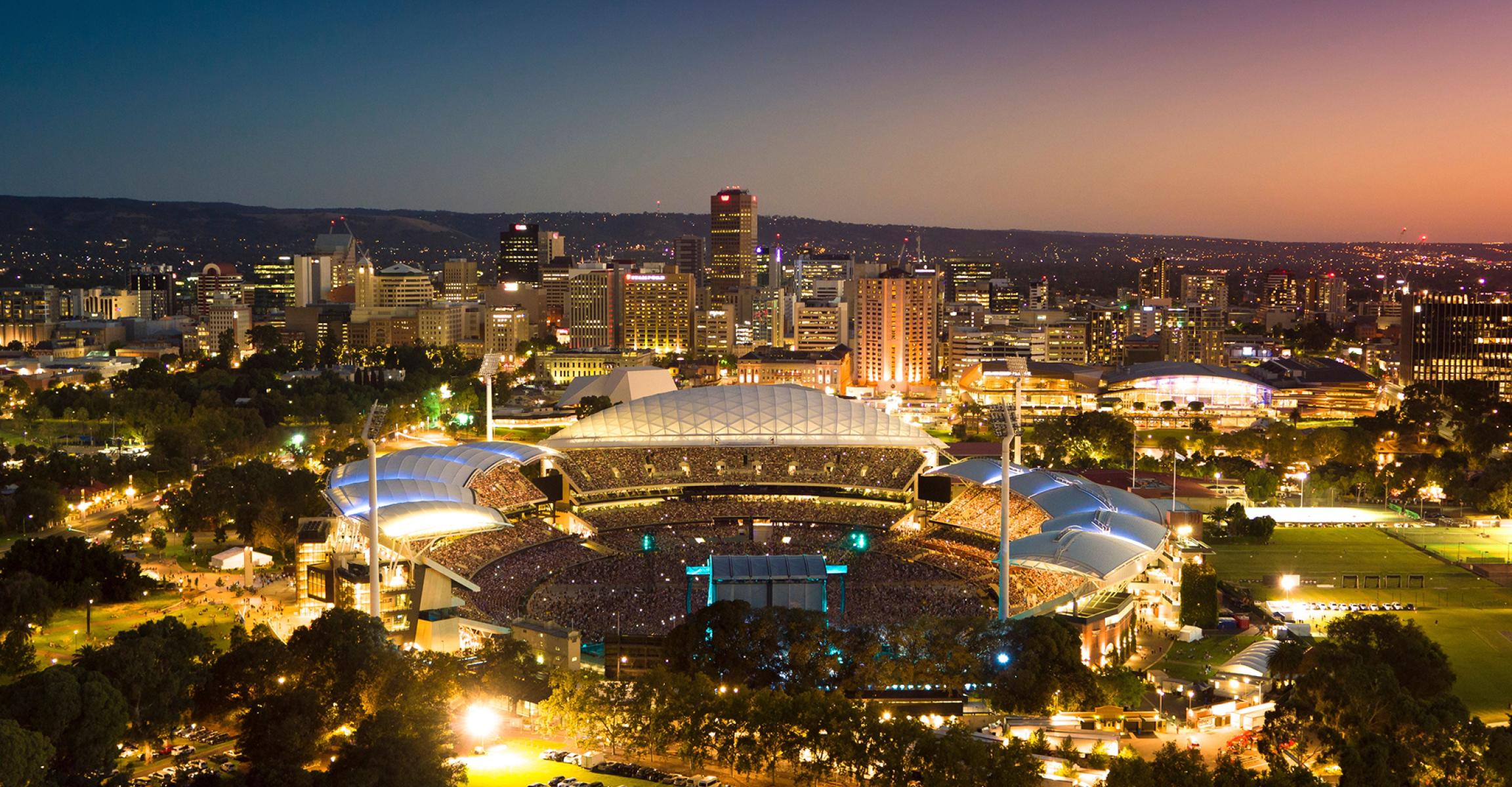 Adelaide Oval aerial at sunset, iconic stadium surrounded by city and parklands, Adelaide, SA.