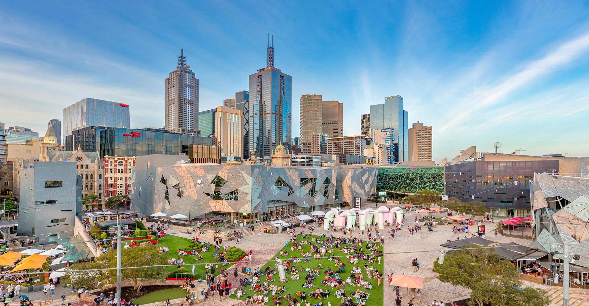 Elevated view of a bustling Federation Square in Melbourne CBD with crowds enjoying a sunny event