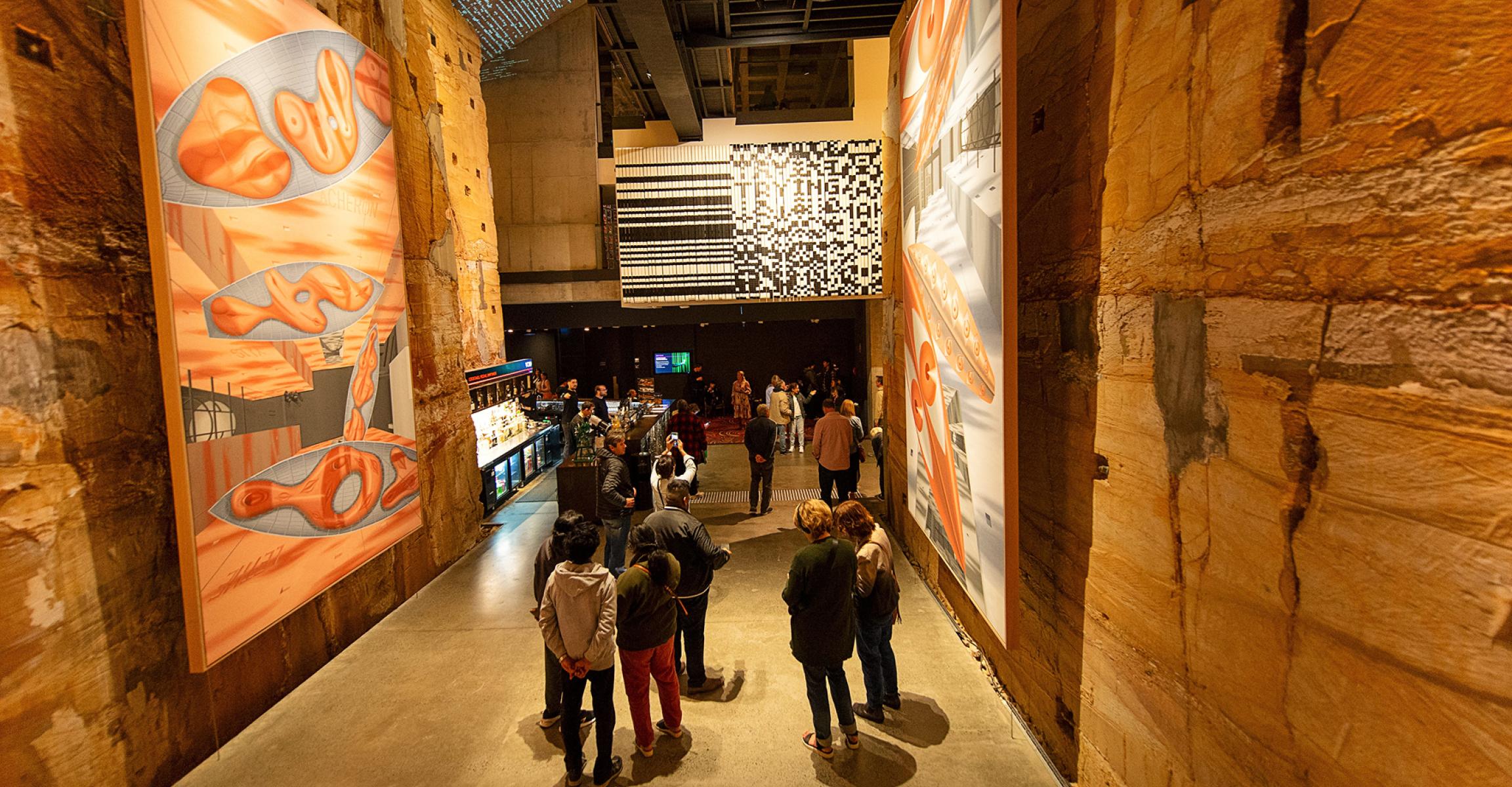 Guests walking through an exhibition hall at MONA.