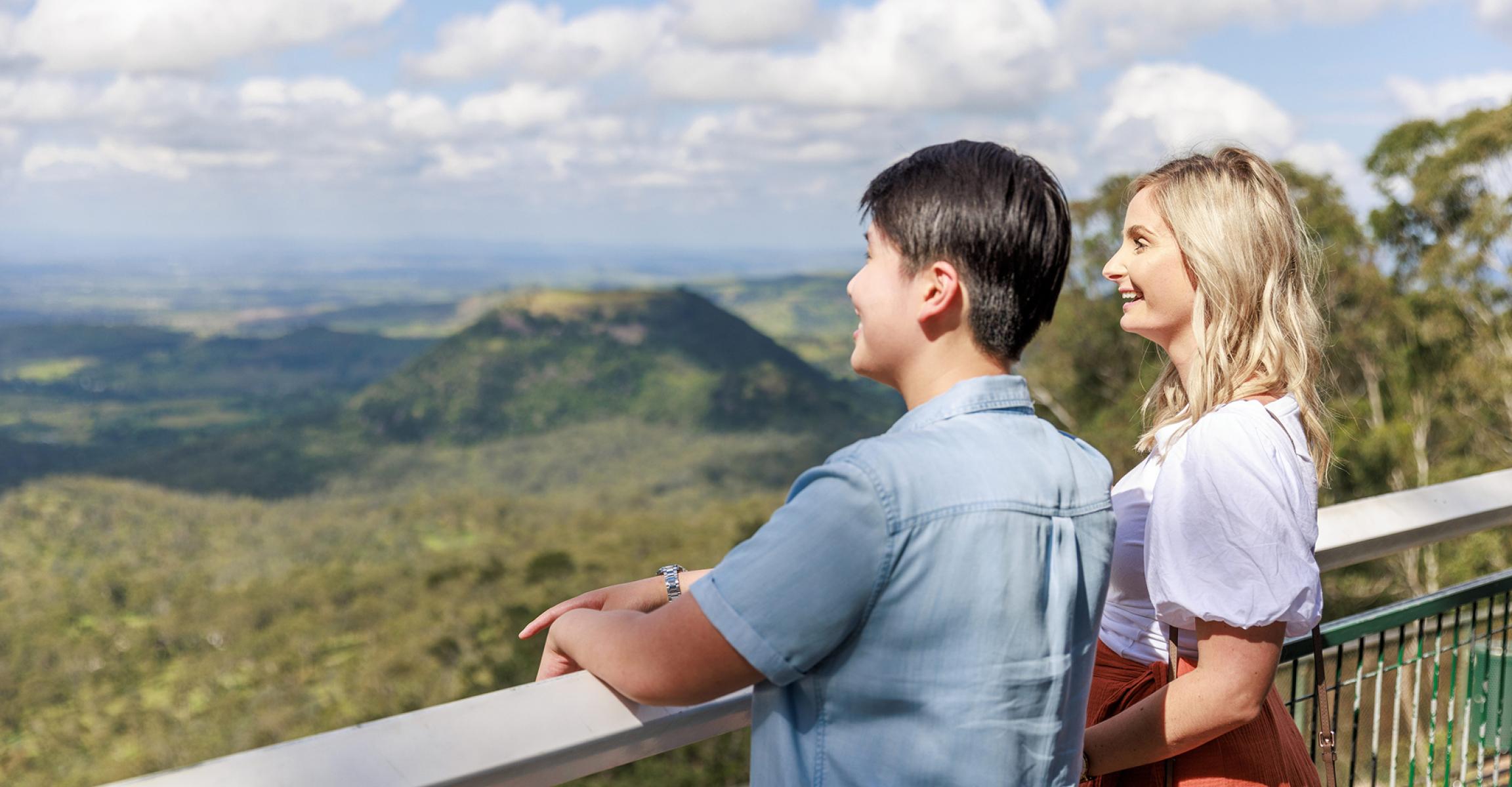 Pair standing at a lookout overlooking a national park.